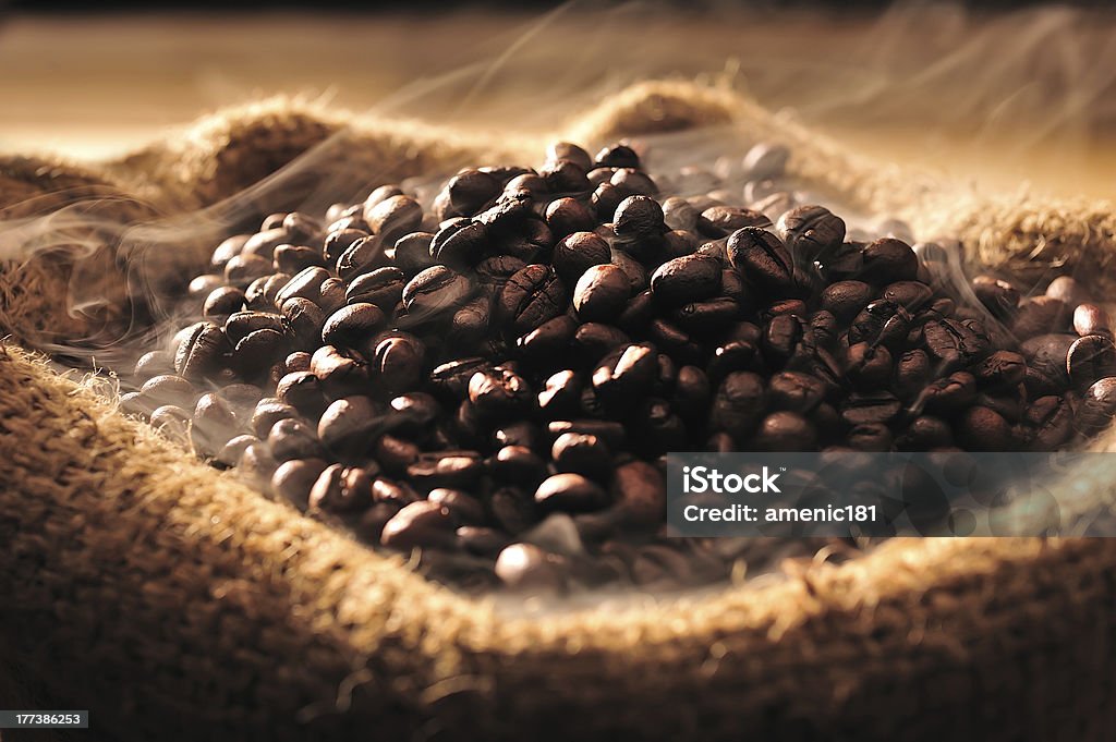 coffee beans Coffee beans with smoke in burlap sack Coffee Crop Stock Photo