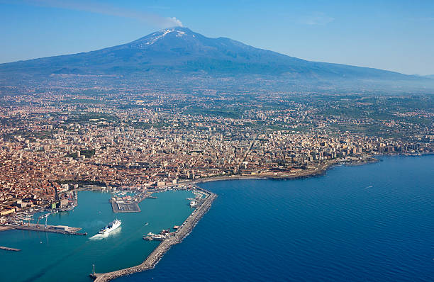 Catania and Etna - Air photo Air photo of Catania city in Sicily with the Etna Vulcan in the back. mt etna stock pictures, royalty-free photos & images