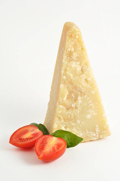 piece of parmesan with tomato stock photo