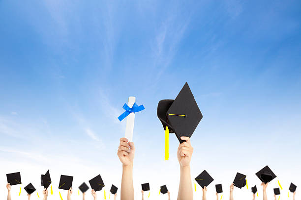 istock hand holding graduation hats and diploma 177389590