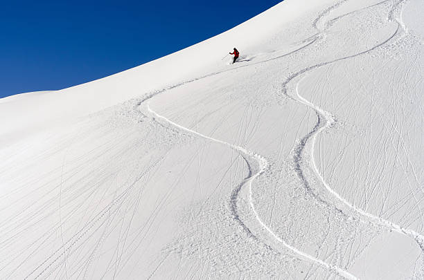 Skiers in deep snow stock photo