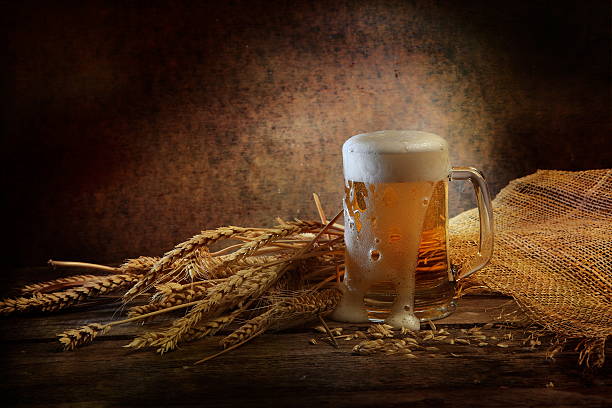 beer poured from a cup on the table stock photo