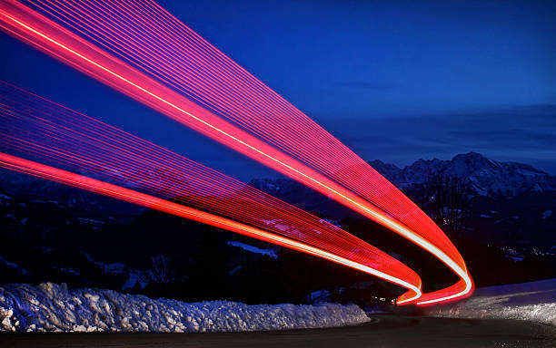 Light trails on a highway LED taillights of a car driving on a highway. tail light stock pictures, royalty-free photos & images
