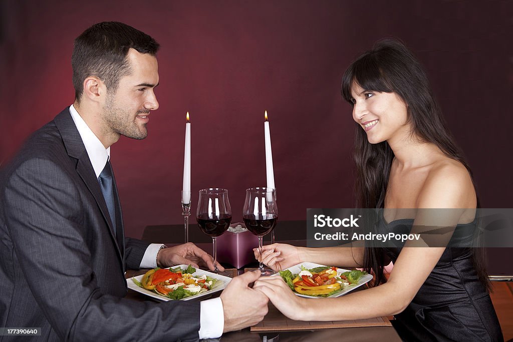 Couple at romantic dinner in restaurant Lovely young couple having romantic dinner in restaurant Adult Stock Photo