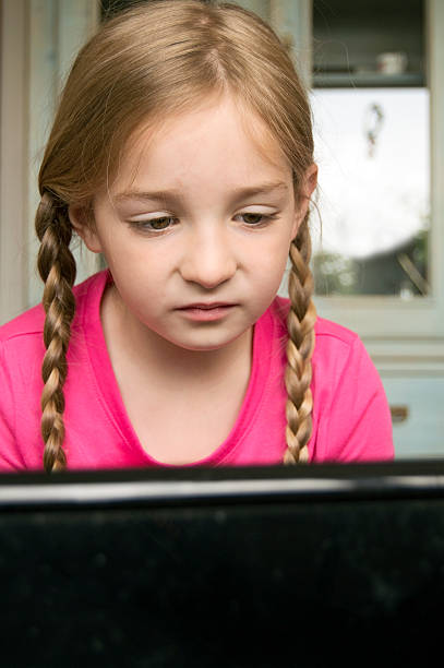 concentrated girl at computer stock photo