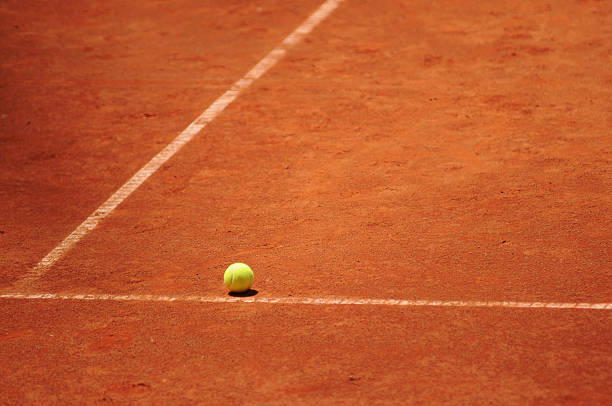Tennis ball on the court stock photo