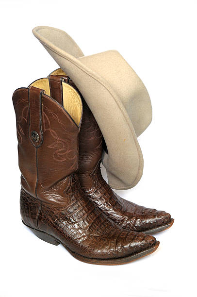 istock Brown cowboy boots and felt hat on white background 177391231