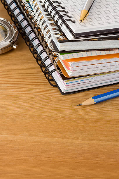 istock notebook and pens on wood background 177391912