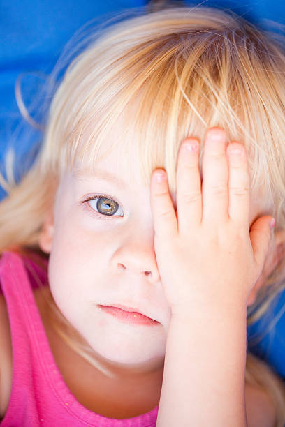 istock Little Girl With Hand Over One Eye 177392220
