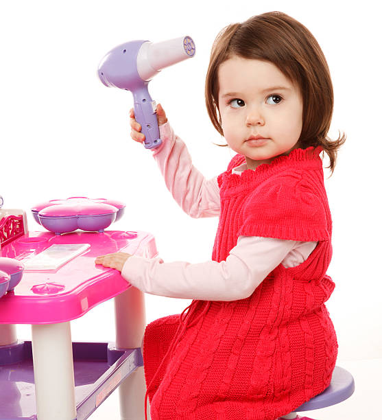 Little girl with hairdryer stock photo