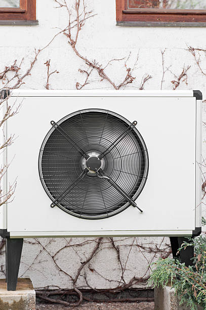 istock Air/Heat fan mounted on outside wall with vines growing 177393955