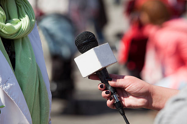 istock Close up of a microphone during an outdoor interview 177394295