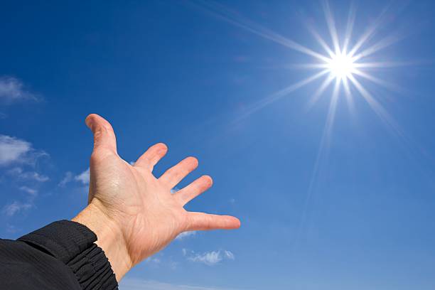 people hand pointing to a sun