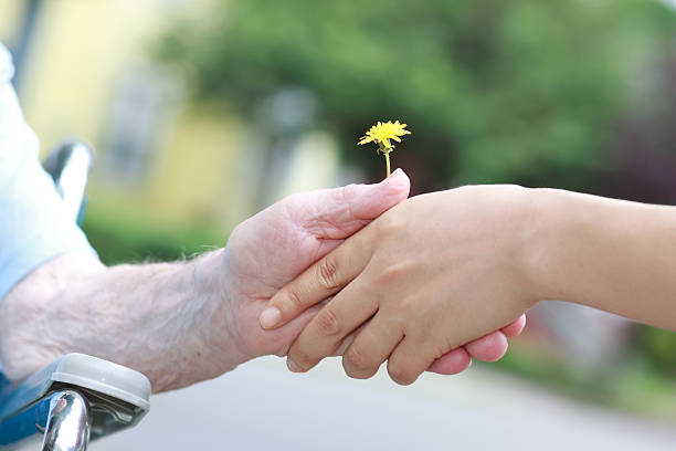 istock Young and senior women holding a dandelion 177394634