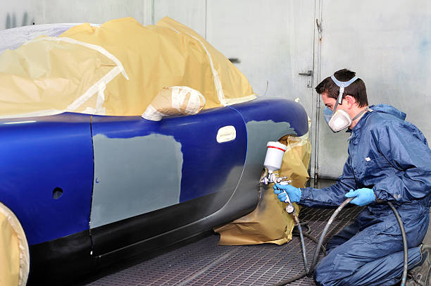 istock Worker is professionally painting a vehicle royal blue 177395391