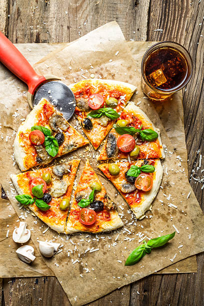 istock Cutting homemade pizza with basil 177395464