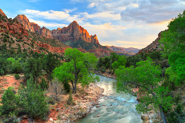 Zion Canyon Sunset HDR HDR image of the last rays of sun hitting The Watchman with the Virgin River in the foreground in Zion National Park, Utah. zion river stock pictures, royalty-free photos & images