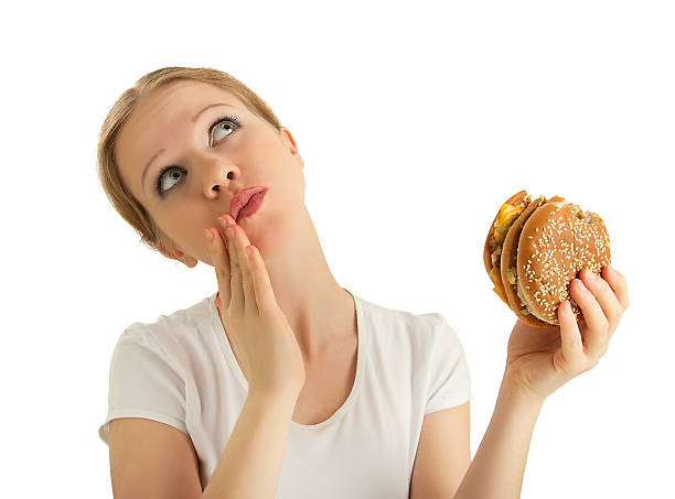 hungry beautiful girl eats a tasty hamburger