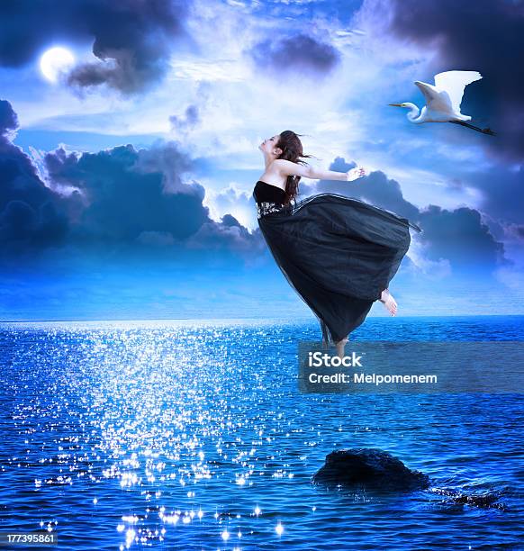 Beautiful Girl Jumping Into The Blue Night Sky Stock Photo - Download Image Now - Flying, Moon, Women