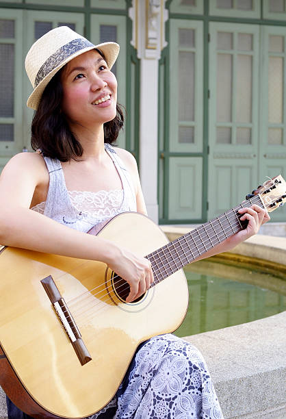 istock woman with guitar 177396007