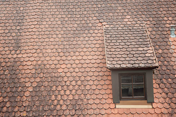 antique window on roof stock photo