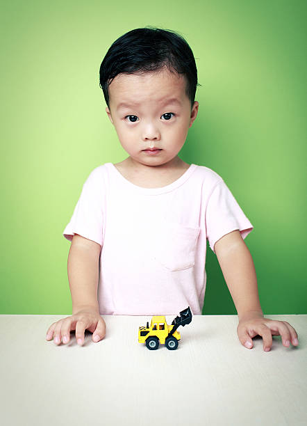 Cute Asian boy and toy car