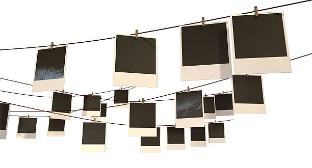 Hanging Photograph Gallery A gallery of blank photographs pegged onto multidirectional red strings on an isolated background string photos stock pictures, royalty-free photos & images