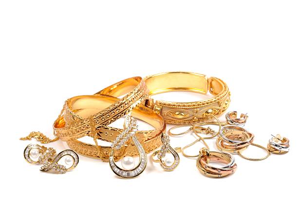 Gold jewelry laying in a small pile Golden bracelets and jewelry sets, over white gold earring photos stock pictures, royalty-free photos & images