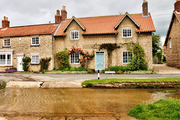 istock English village with ford. 177403165