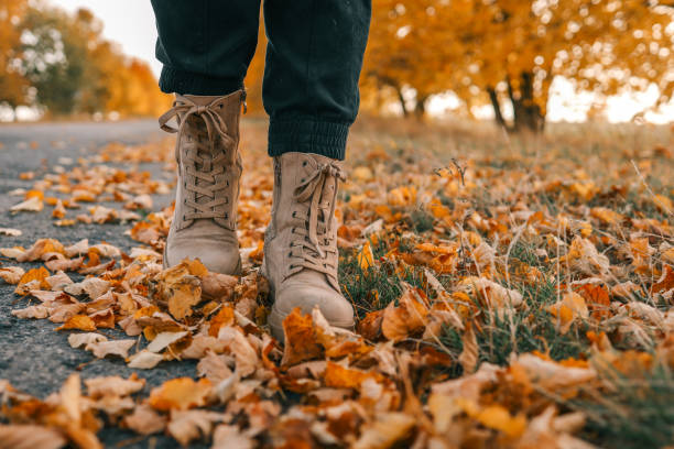 istock A man walks along an autumn road, boots close-up 1774031810