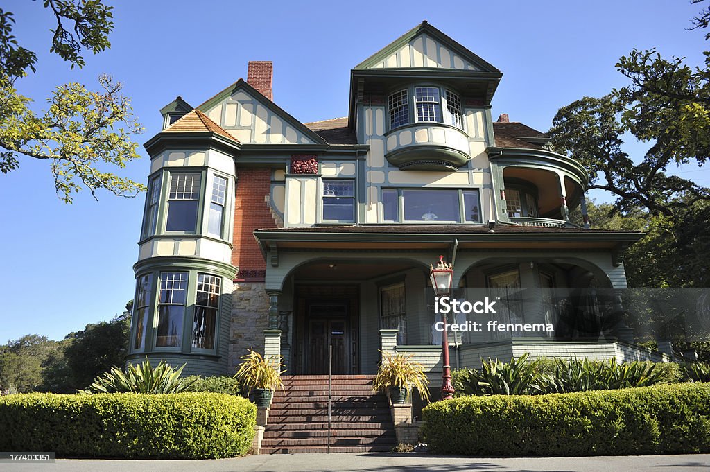 Classic victorian house with hedge in front A victorian house with bay windows with driveway and hedge in front Victorian Style Stock Photo