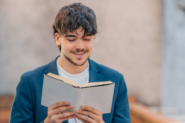 istock student with textbook reading on the street 1774039222
