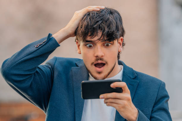 istock young male with mobile phone and surprised face 1774039539