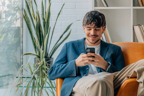 istock young man sitting with mobile phone or smartphone 1774039574