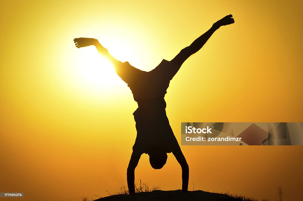 Man in the sunset jump and shout Activity Stock Photo