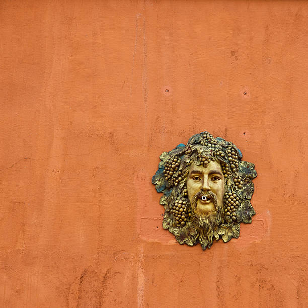 istock cast metal face man head on the orange wall 177404302