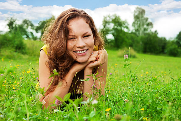 istock nice girl laying on green grass 177404820