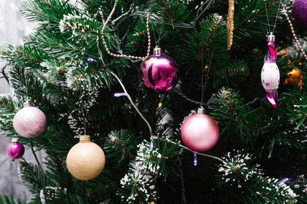 istock Pink Christmas balls hang on the tree. Copy space 1774048414