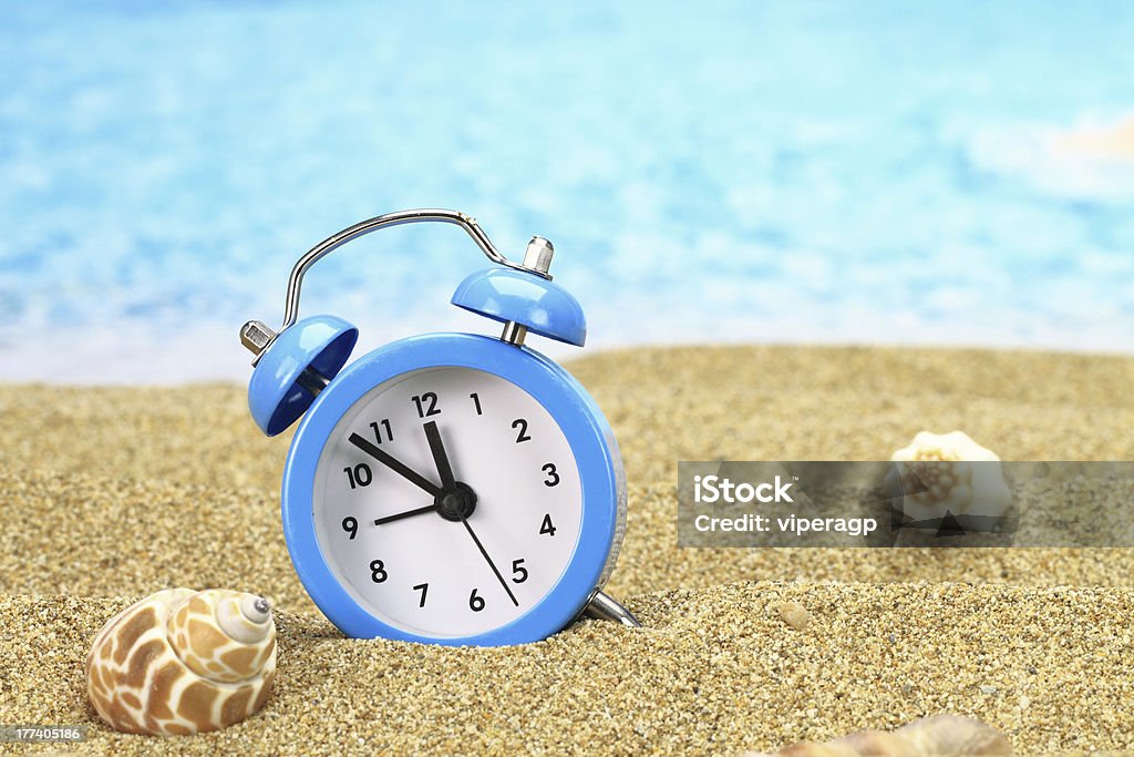 Vacation time Vacation time. Alarm clock on the sand Alarm Clock Stock Photo