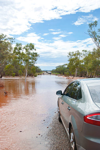 Flooded road and waiting car