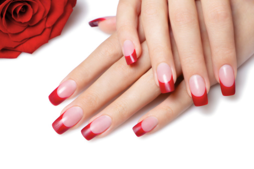 Groomed female hands with red nails.