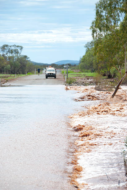 istock 4WD waiting to cross flooded road 177405752