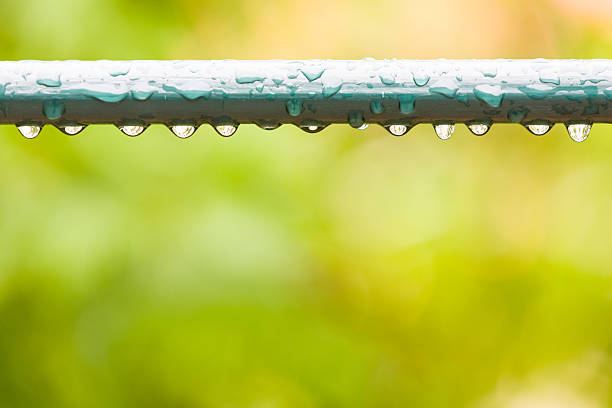 Raindrops on a fence in city park or garden stock photo