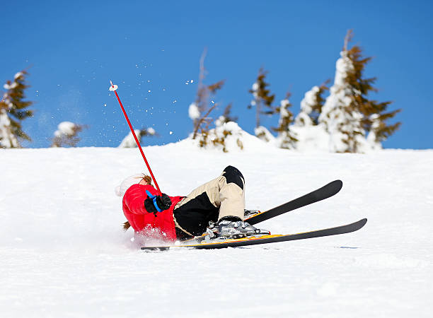 Girl fallen down in the snow while cross country skiing.
