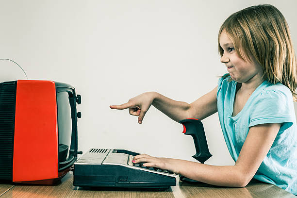 peeved little girl frustrated with retro tv and video games - gamer video game 1980s style television stok fotoğraflar ve resimler