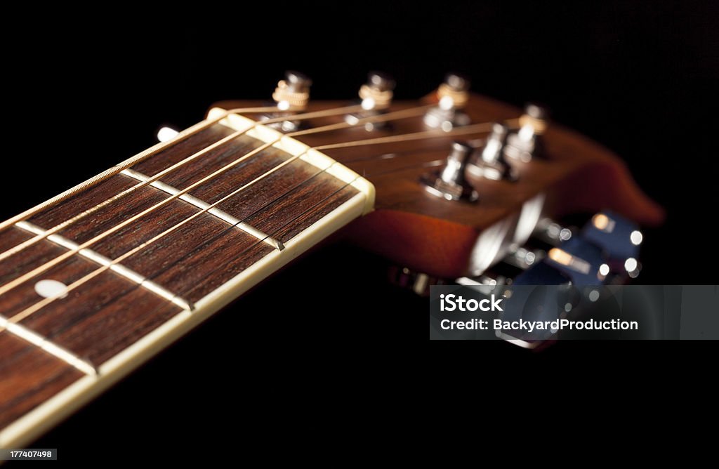 View down the fretboard of guitar Macro shot down the fretboard of acoustic guitar with shallow depth of field Acoustic Guitar Stock Photo