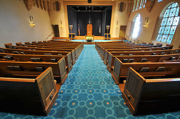 Rows of pews in a synagogue Pews in a synagogue facing the stage area synagogue stock pictures, royalty-free photos & images