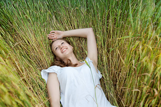 istock Beautiful woman smiles in field 177407846