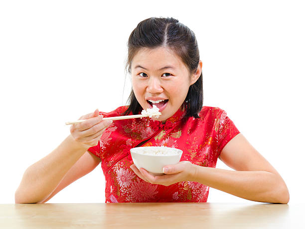 mulher comer arroz asiático - chopsticks human hand women isolated - fotografias e filmes do acervo