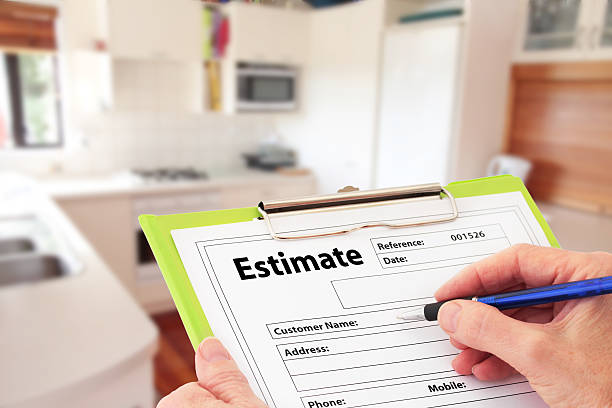 Hand Writing an Estimate for Kitchen Renovation stock photo